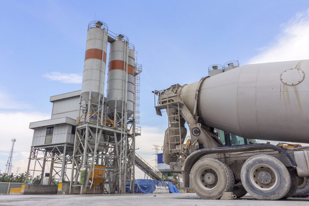 Concrete trucks in front of cement factory in afternoon