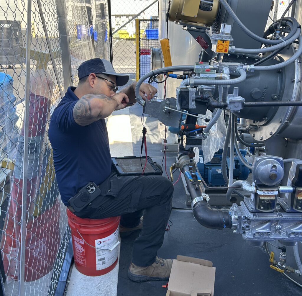 Man working on system, replacing parts.
